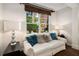 Cozy sitting area with white couch and decorative pillows next to large window and lamps at 850 Piedmont Ne Ave # 1206, Atlanta, GA 30308