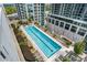 Stunning aerial view of a rooftop pool surrounded by lounge chairs and lush landscaping at 855 Peachtree Ne St # 2205, Atlanta, GA 30308