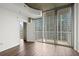 Bedroom with hardwood floors, concrete ceiling, and sliding doors to a balcony at 855 Peachtree Ne St # 2205, Atlanta, GA 30308