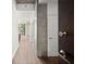 Hallway with hardwood floors and concrete accent wall seen through open door at 855 Peachtree Ne St # 2205, Atlanta, GA 30308