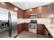 Kitchen with stainless steel appliances, granite countertops, and dark wood cabinets at 855 Peachtree Ne St # 2205, Atlanta, GA 30308