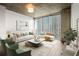 Living room with modern furniture, large windows, and concrete ceilings at 855 Peachtree Ne St # 2205, Atlanta, GA 30308