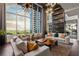 Elegant lounge with floor-to-ceiling windows showcasing city views and stylish decor at 855 Peachtree Ne St # 2205, Atlanta, GA 30308