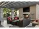 Relaxing outdoor space featuring comfortable seating, a fireplace, and a flat-screen TV under a pergola at 855 Peachtree Ne St # 2205, Atlanta, GA 30308