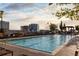 Relaxing rooftop pool area, complete with lounge chairs, greenery, and city views at 855 Peachtree Ne St # 2205, Atlanta, GA 30308