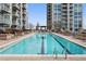 Beautiful rooftop pool with lounge chairs, a pergola, and city views at 855 Peachtree Ne St # 2205, Atlanta, GA 30308