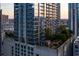 Scenic rooftop terrace with a dining area, lush trees, and breathtaking city views at 855 Peachtree Ne St # 2205, Atlanta, GA 30308