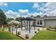 An expansive backyard offers outdoor dining area with a pergola, patio and well manicured lawn at 2711 Bluffton Rd, Buford, GA 30519