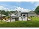 Well-manicured backyard features a patio with dining, hammock, privacy fence and lush green grass at 2711 Bluffton Rd, Buford, GA 30519