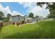Backyard view of patio with hammock and seating, lush lawn, privacy fence, and mature trees at 2711 Bluffton Rd, Buford, GA 30519