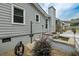 Backyard showcasing outdoor shower, a serene rock waterfall and patio with dining area and mature landscape at 2711 Bluffton Rd, Buford, GA 30519