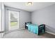 Bright bedroom features a cozy bed, large window and neutral gray walls creating a serene and restful atmosphere at 2711 Bluffton Rd, Buford, GA 30519