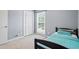 Bright bedroom featuring a cozy bed, closet for storage and a large window that lets in natural light at 2711 Bluffton Rd, Buford, GA 30519