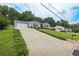 Long driveway leading to a one-story home with an attached garage, providing ample parking space at 2711 Bluffton Rd, Buford, GA 30519
