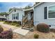 Inviting front entrance with wooden steps and black shutters, enhancing curb appeal at 2711 Bluffton Rd, Buford, GA 30519