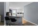 The kitchen features bar stool seating at the granite countertop and stainless steel appliances at 2711 Bluffton Rd, Buford, GA 30519