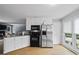 The kitchen features white cabinets, granite countertops, and stainless steel appliances at 2711 Bluffton Rd, Buford, GA 30519