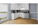 Kitchen featuring white cabinets, hardwood floors, granite countertops, and stainless steel appliances at 2711 Bluffton Rd, Buford, GA 30519