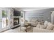 Relaxing living room featuring a cozy fireplace, glass shelves, and an inviting outdoor view at 2711 Bluffton Rd, Buford, GA 30519
