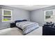 Spacious main bedroom with two windows, gray walls, and neutral carpet at 2711 Bluffton Rd, Buford, GA 30519