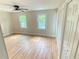 Bedroom featuring gleaming hardwood floors, two windows, and double door closets for ample storage at 323 West Claiborne Ct, Marietta, GA 30066