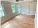 Bright bedroom featuring gleaming hardwood floors, two windows, and double door closets for ample storage at 323 West Claiborne Ct, Marietta, GA 30066