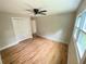 This bedroom features hardwood floors, a ceiling fan, neutral paint, and double door closet at 323 West Claiborne Ct, Marietta, GA 30066