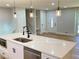 Modern kitchen with white cabinetry, quartz countertops, stainless steel appliances, and a kitchen island at 323 West Claiborne Ct, Marietta, GA 30066