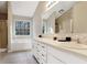Bright bathroom with dual sinks, white cabinets, and a large window at 3337 Camens Way, Buford, GA 30519