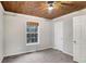 Bedroom featuring a unique wood ceiling and natural light from the window at 3337 Camens Way, Buford, GA 30519