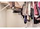 A closet with black hangers and a variety of clothes at 3337 Camens Way, Buford, GA 30519