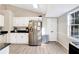 Bright kitchen with white cabinets, modern appliances and a window at 3337 Camens Way, Buford, GA 30519