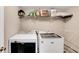 Laundry room featuring white washer and dryer units and storage shelf at 3337 Camens Way, Buford, GA 30519
