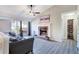 Living room featuring a brick fireplace, hardwood floors, a vaulted ceiling with fan, and a large window at 3337 Camens Way, Buford, GA 30519