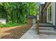 Backyard area with a small storage shed and steps to the patio, nestled among mature trees at 4339 Rushmore Pl, Forest Park, GA 30297
