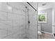 Bathroom with tiled shower features granite countertops, white tile and a modern shower head at 4339 Rushmore Pl, Forest Park, GA 30297
