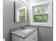 Bathroom features a window, granite countertop and modern fixtures at 4339 Rushmore Pl, Forest Park, GA 30297