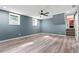 Spacious bedroom with hardwood floors, two windows, a ceiling fan and access to a staircase at 4339 Rushmore Pl, Forest Park, GA 30297
