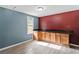 Bonus room with wooden built-ins, two-tone walls, and vinyl floors at 4339 Rushmore Pl, Forest Park, GA 30297