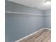 Walk-in closet with built-in wire shelving and wood-look floors at 4339 Rushmore Pl, Forest Park, GA 30297