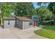 Gray two-story home featuring well-maintained landscaping, a driveway, and a bright red front door at 4339 Rushmore Pl, Forest Park, GA 30297