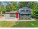 Inviting two-story home featuring gray siding, black shutters, and a striking red front door at 4339 Rushmore Pl, Forest Park, GA 30297