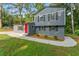 Inviting two-story home featuring gray siding, black shutters, and a striking red front door at 4339 Rushmore Pl, Forest Park, GA 30297