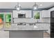 Modern kitchen features white cabinets, granite countertops and stainless steel appliances at 4339 Rushmore Pl, Forest Park, GA 30297