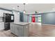 Modern kitchen open to the living room with stainless steel appliances and pendant lighting at 4339 Rushmore Pl, Forest Park, GA 30297