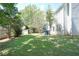 Beautiful backyard featuring a shed, mature trees, and partial view of house at 4845 Weathervane Dr, Alpharetta, GA 30022