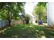 Great backyard space with grass, shed, surrounded by trees, and a wood fence at 4845 Weathervane Dr, Alpharetta, GA 30022