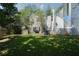 Beautiful backyard featuring a shed, mature trees, partial view of house, grass lawn at 4845 Weathervane Dr, Alpharetta, GA 30022
