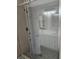 Glass shower enclosure over a unique honeycomb tile floor, with a matching vanity at 4845 Weathervane Dr, Alpharetta, GA 30022