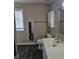 Bathroom featuring a modern vanity with updated fixtures, toilet, and framed mirror at 4845 Weathervane Dr, Alpharetta, GA 30022